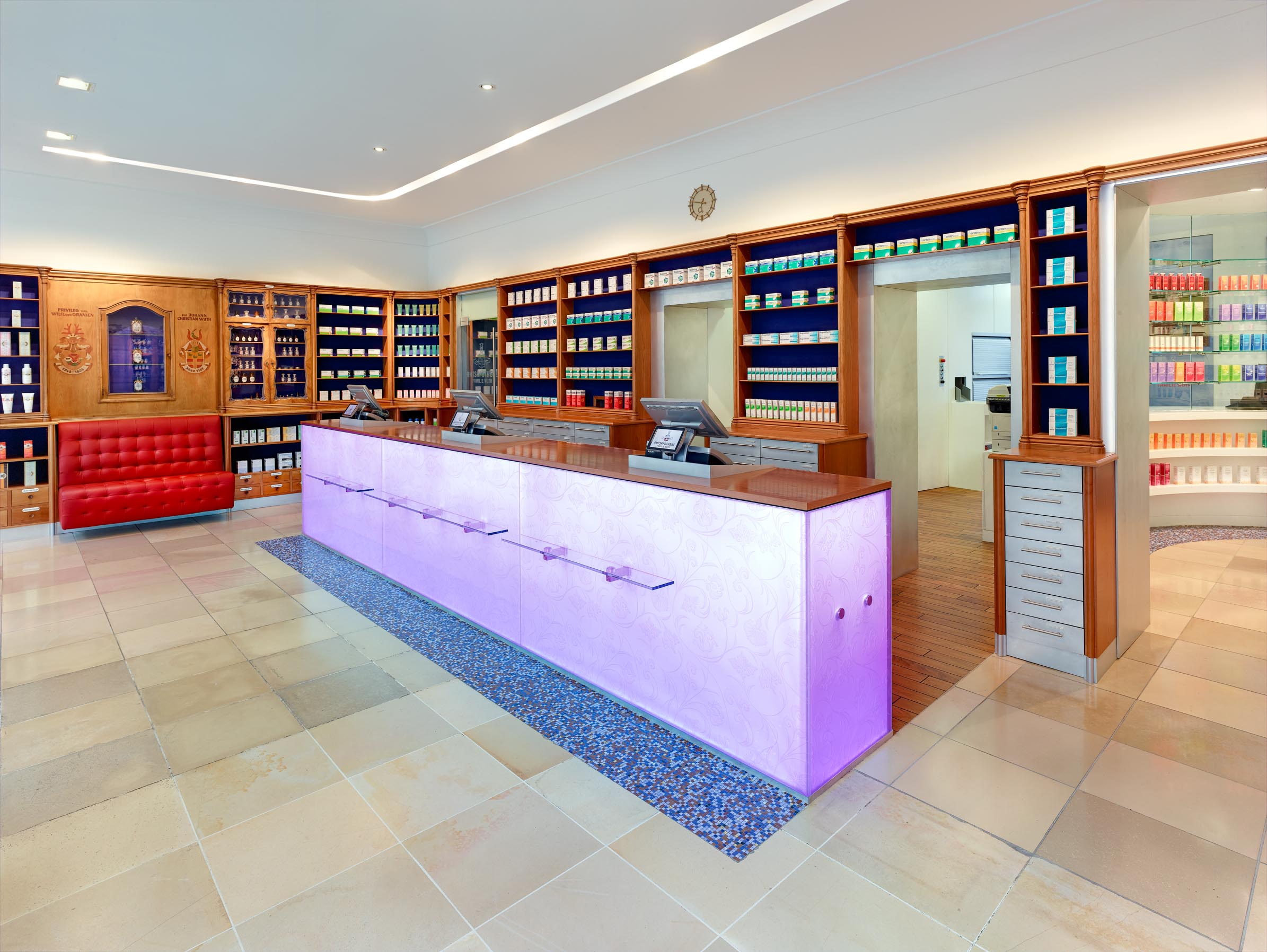 Overview of the dispensary with shop window, historic furnishings and new self-service area