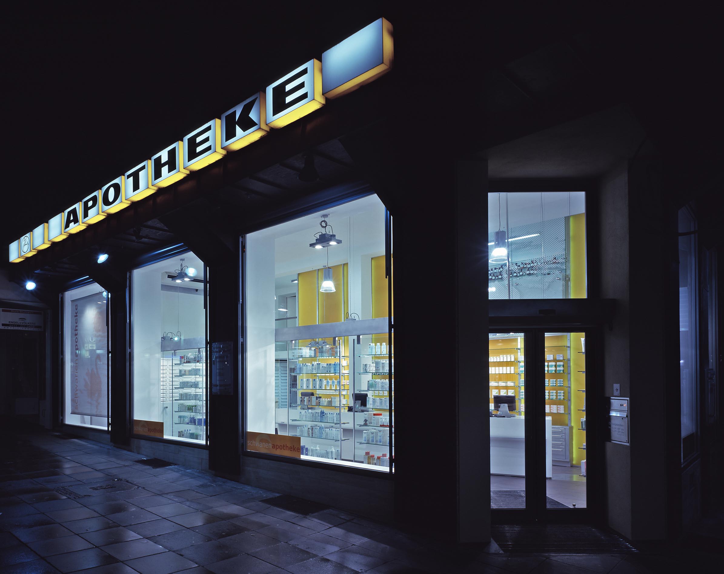 Façade with illuminated signage and shop windows