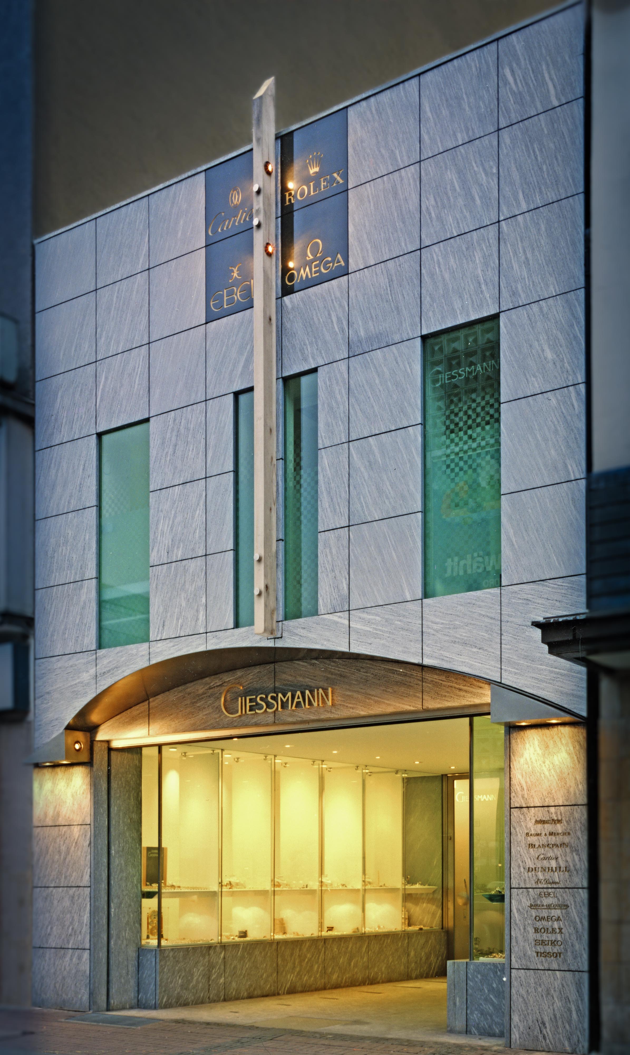 Facade of the Giessmann watch shop with natural stone cladding and shop windows